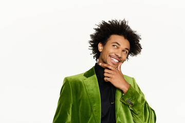 Young man in elegant green attire showcases charm and confidence in a bright setting