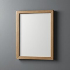 A blank wooden frame hangs on a gray wall. The frame is rectangular with a light wood finish, suitable for displaying artwork or photographs.