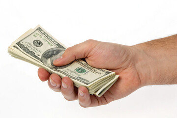 Hand gripping several US hundred-dollar bills, symbolizing income, profit, financial power, capital management, economic value, investment returns, transaction success, and monetary confidence in 