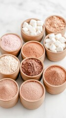 Fototapeta premium Assortment of powders and marshmallows in wooden bowls on a white surface.