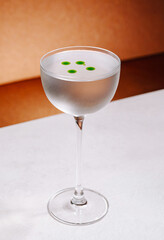 Elegant cocktail served in a chilled glass with vibrant green accents