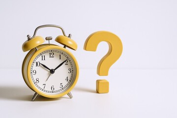 Yellow Alarm Clock with Question Mark: Time Management, Deadline Concept, and White Background