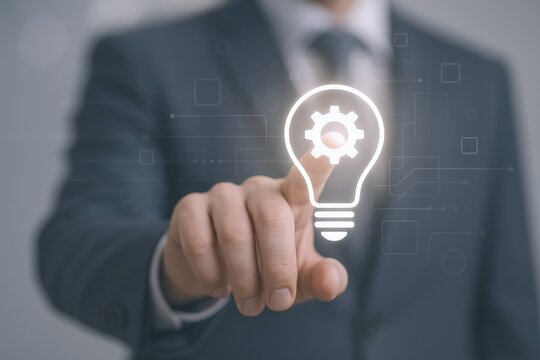 Innovative Businessman Touching a Light Bulb Icon with a Gear in the Center for Business Idea