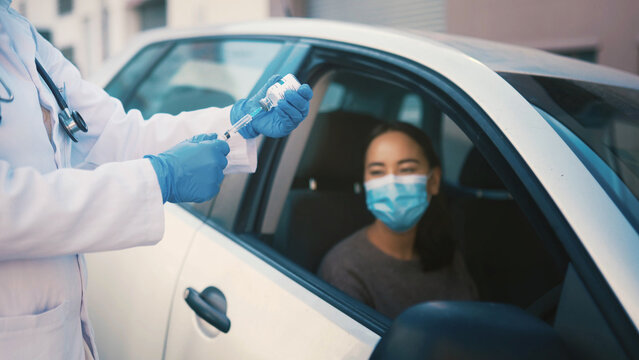 Healthcare, patient and hands with vaccine, car or injection for Covid prevention and communication. Drive tru, medical help and consultation for RSV immunization, medicine and woman in vehicle