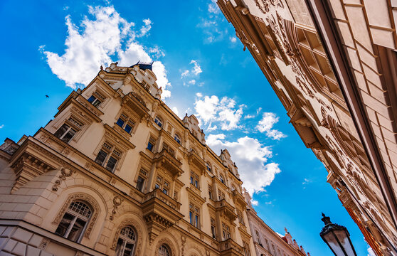 Colorful historic buildings line Prague street. - Powered by Adobe