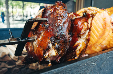 Traditional Prague pork street food roasting on spit.