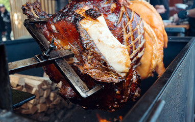 Traditional Prague pork street food roasting on spit.