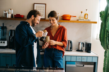 Couple enjoy coffee together in modern kitchen