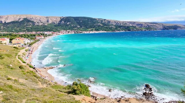 Stunning panorama of vibrant coastal village and turquoise sea waves under clear blue sky. Ba&scaron;ka, Krk island, Croatia