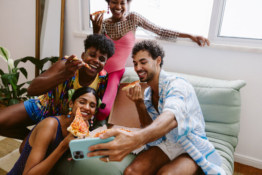 Friends gather for a selfie at a pizza party - Powered by Adobe