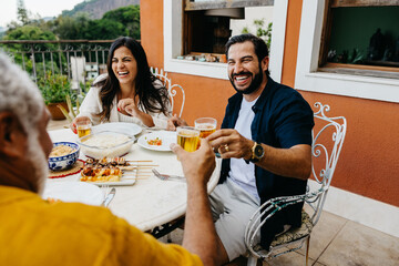 Friends sharing a cheerful barbecue meal in an outdoor setting