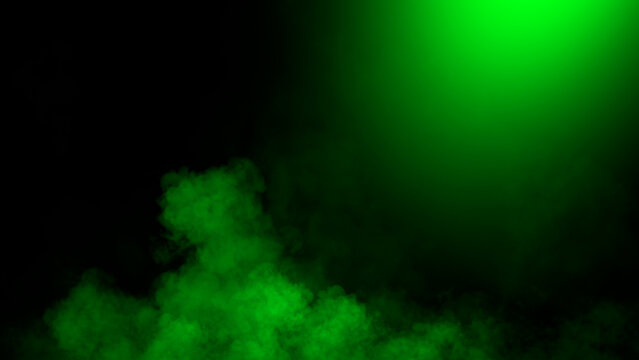 Divine light through a dark smoke and fog. The green rays beam light. Spotlight on isolated black background.