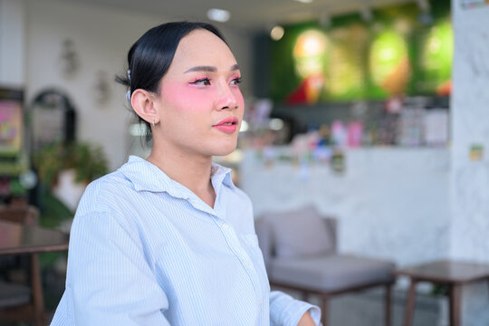 Portrait of a young Thai transgender business person at coffee shop - Powered by Adobe