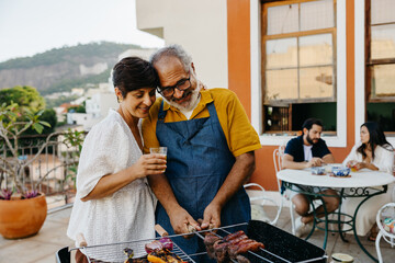 Family enjoying a traditional Brazilian churrasco on a sunny outdoor patio