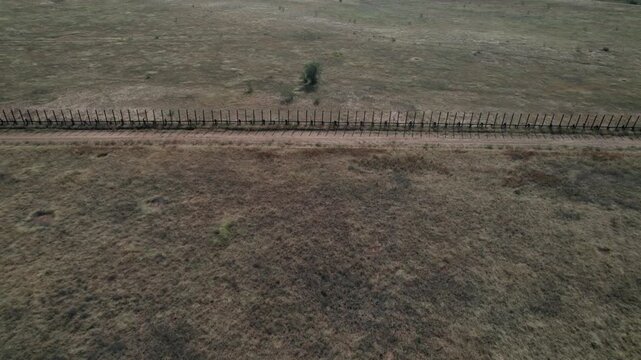 Aerial of the fence along a section of the US - Mexico border