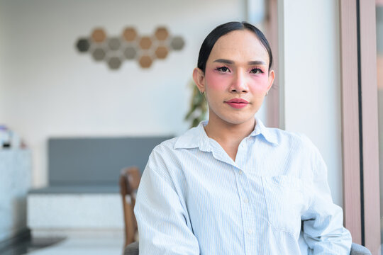 Portrait of a young Thai transgender business person at coffee shop - Powered by Adobe