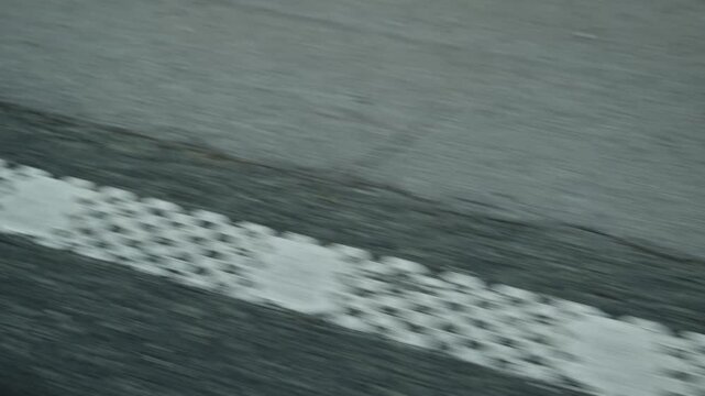 Abstract POV highway perspective with dashed road markings, symbolizing journey, direction, and movement along asphalt surface in continuous forward motion. 4K.