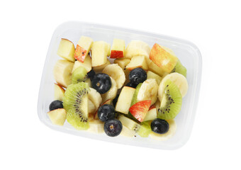 Tasty fruit salad in plastic container isolated on white, top view. Healthy snack
