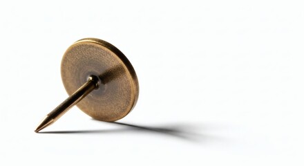 Brass Tack A golden fastener casts a shadow on white Detail shot.