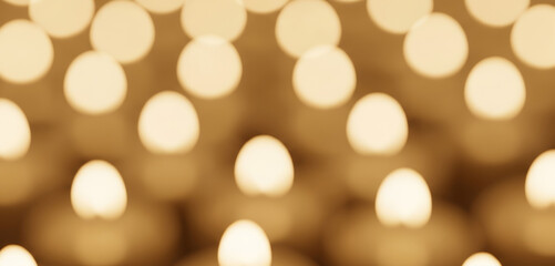 Fully blurred Christmas candlelight with beige and golden tones. Smooth circular bokeh and balanced light distribution arranged for background use.
