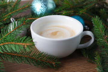Aromatic coffee and Christmas decor on wooden table, closeup