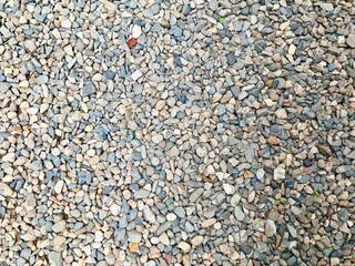 Textured ground covered in small stones, ideal for construction or landscaping projects in outdoor settings