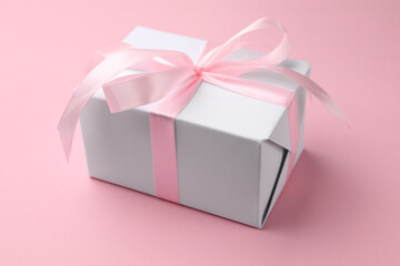 Beautiful gift box on pink background, closeup