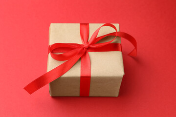 Beautiful gift box on red background, closeup