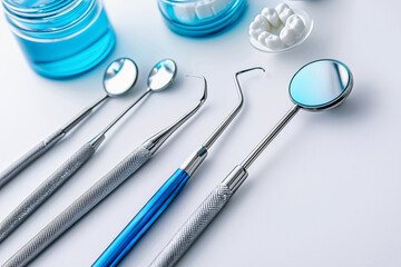 High quality close-up of stainless steel dental instruments on a sterile clinical table. Professional dental check-up. Dental clinic, equipment catalog, websites, brochures or promotional stock use.
