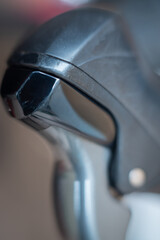 Close-up of a bicycle metallic lever with smooth reflections and soft background blur, highlighting its texture and modern mechanical design