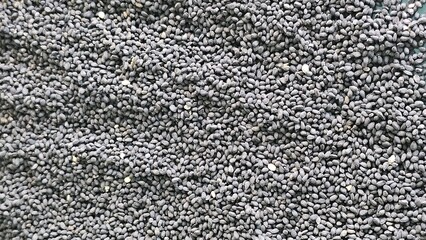 Black sesame or cumin seeds scattered loose for easy viewing and selection at an Asian market...