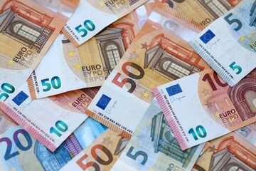 Euro money bills banknotes in big amount on table close up. Huge quantity of European Union currency cash on smooth surface. Business and rich life concept