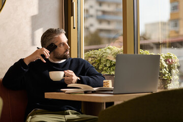 Stylish man enjoying coffee while contemplating in a cozy cafe setting at midday