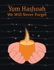 Human hands hold a burning candle in memory of the victims of the Holocaust