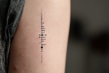 Tattooed Metronome: Vertical Rib Design with Clean Tempo Dots on Skin