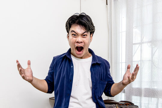 Asian man emotions facial expression gestures hands close-up blue background