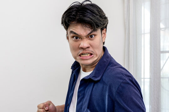 Asian man emotions facial expression gestures hands close-up blue background