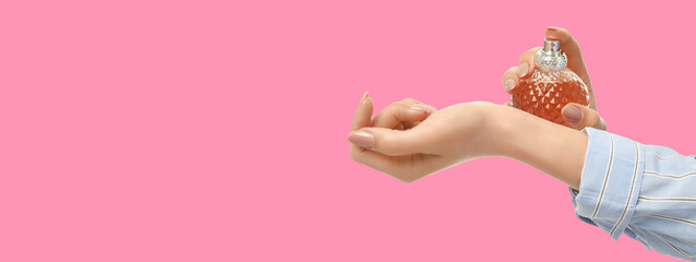 A person sprays perfume from a unique bottle