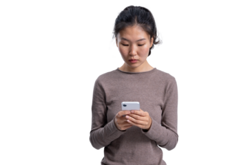 Young Asian woman wearing casual sweater holding smartphone, standing and focused, isolated on white background, useful for collage or template