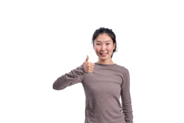 Cheerful Asian woman smiling and showing thumbs up gesture, casual outfit, isolated on white background, concept of approval and positivity