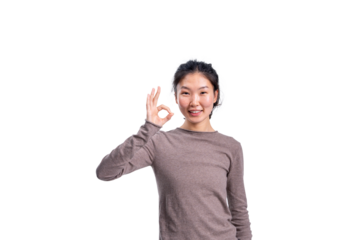 Cheerful Asian woman giving OK sign with hand, casual style, isolated on white background. Concept of positivity, approval, and confidence