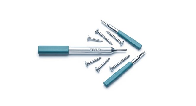 Screws and screwdrivers with turquoise handles lying on a white background for construction or maintenance projects