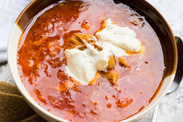 Delicious and aromatic red soup with meat, Ukrainian borscht with sour cream. Traditional Ukrainian dish, cuisine
