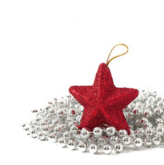 Sparkling red star ornament resting on a bed of shiny silver beads