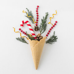 Creative waffle cone arrangement featuring festive red candy sticks and green herbs