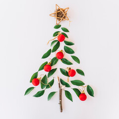 Handmade natural christmas tree decoration crafted with green leaves and red ornaments