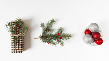 Festive christmas decorations featuring pine branches ornaments and pinecones on a white background