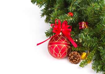 Festive red ornaments and green pine needles adorned with a bright red bow on a white background