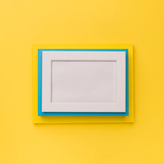 Bright yellow background showcases a colorful rectangular frames with a white center