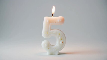 Celebrating Five Years - A Lit Number Candle for a Milestone.
